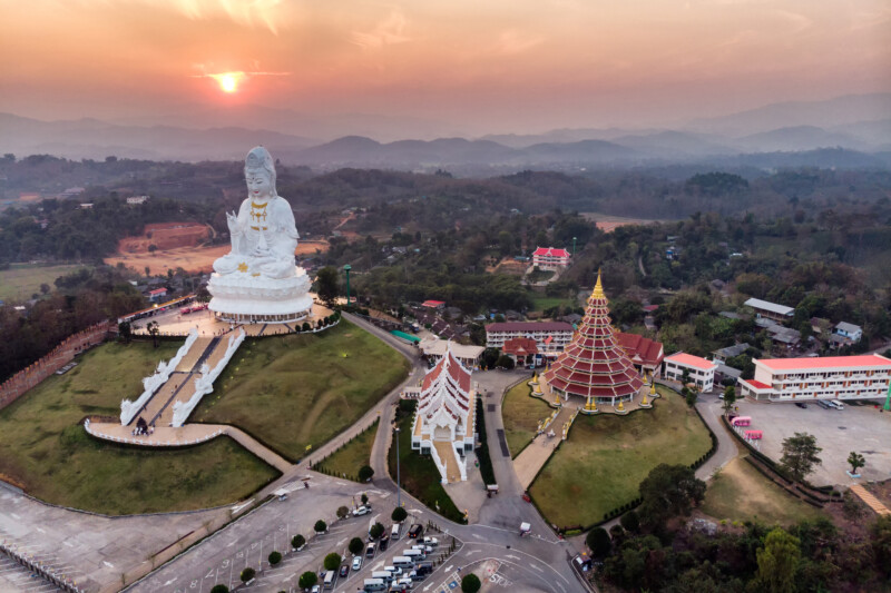Aerial view of Wat Huay Pla Kang temple with Guanyin and church at sunset. Chiang Rai province