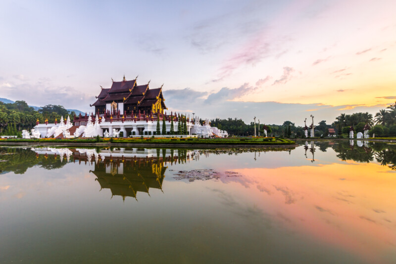 Royal Pavilion, its reflection in pond and bright sky in the morning at Royal Flora Ratchaphruek  park. Chiang Mai, northern Thailand